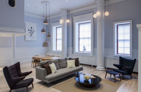 Elegant living room with gray walls, column details, and modern furniture.