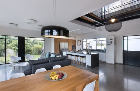 Contemporary open-plan living space with kitchen, dining area, and mezzanine