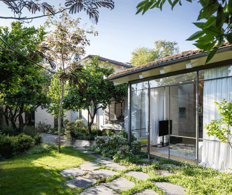 Contemporary glass-walled room overlooking a serene garden.