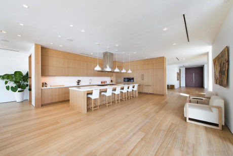 Sleek minimalist kitchen with light wood tones and white accents.