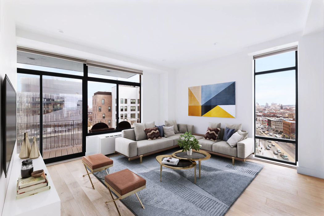 Bright, stylish living room with large windows and city view.