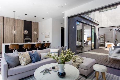 Modern living room with open patio door leading to outdoor space.