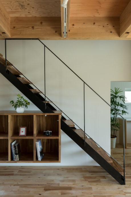 Contemporary staircase with wooden accents and minimalist railings.