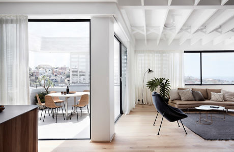 Bright, modern living room with open patio doors and city view.