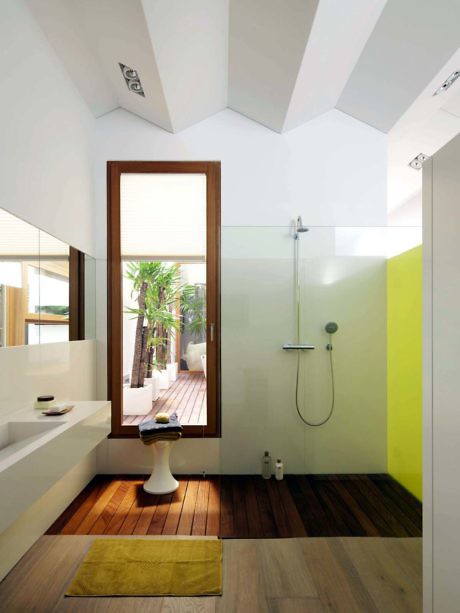 Contemporary bathroom with slanted ceiling and wooden accents