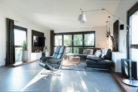 Contemporary living room with sleek furniture and large windows.