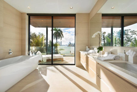 Elegant bathroom with floor-to-ceiling windows and water view.