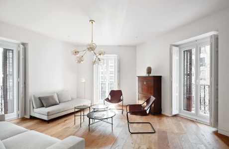 Elegant living room with modern furniture and wooden floors.