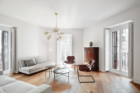 Elegant living room with modern furniture and wooden floors.