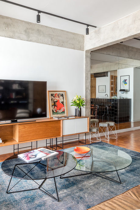 Chic urban living room with exposed beams and mixed textures.