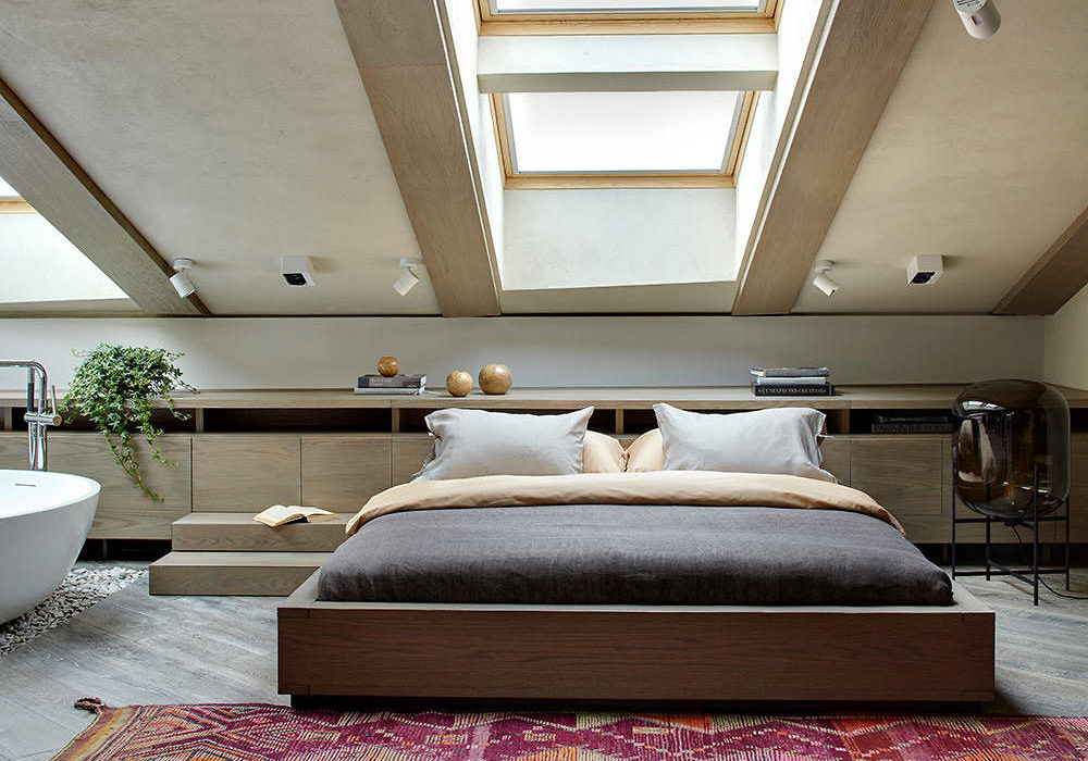 Contemporary attic bedroom with skylights and sleek design.