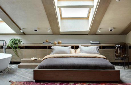 Contemporary attic bedroom with skylights and sleek design.