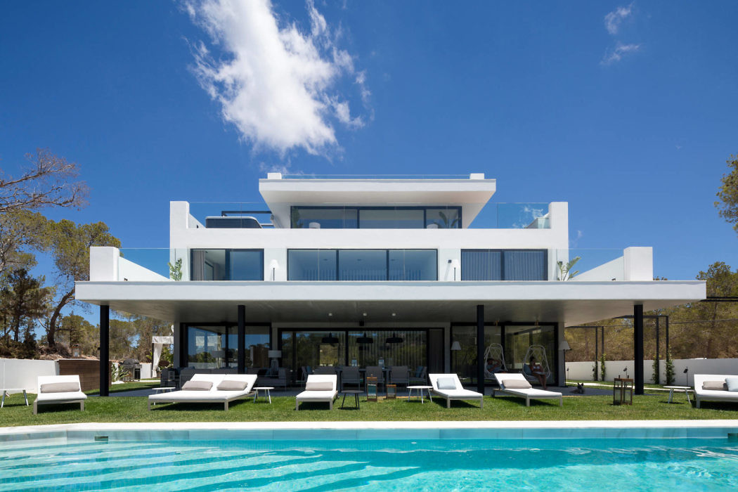 Contemporary white villa with pool and sun loungers