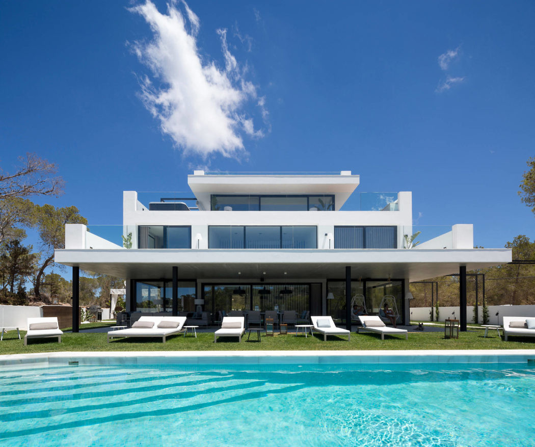 Contemporary white villa with pool and sun loungers