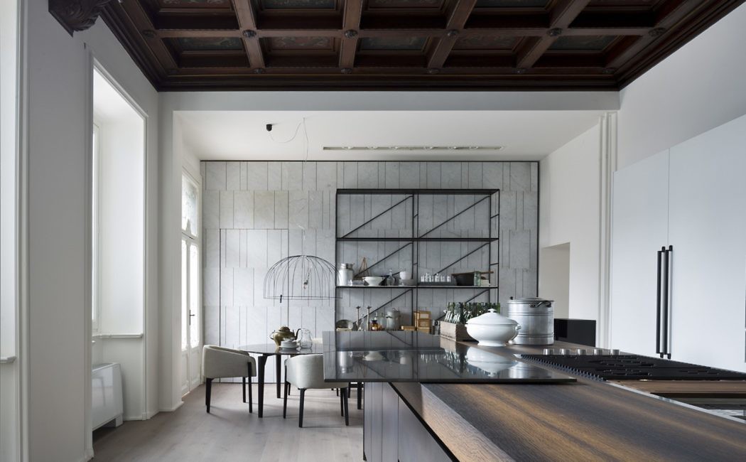 Contemporary kitchen with sleek furnishings and exposed wooden beams.