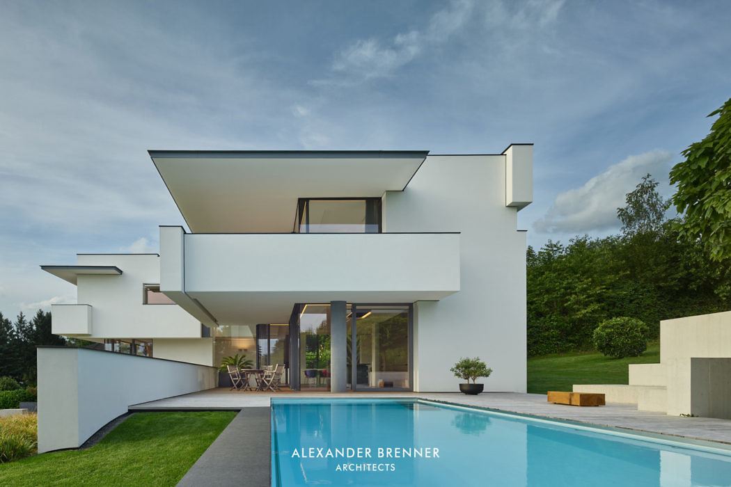 Contemporary white villa with geometric design and pool.