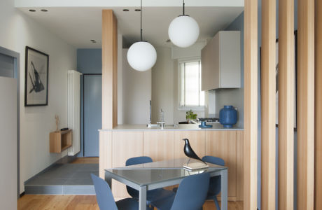 Contemporary kitchen with wood accents and globe pendant lights.