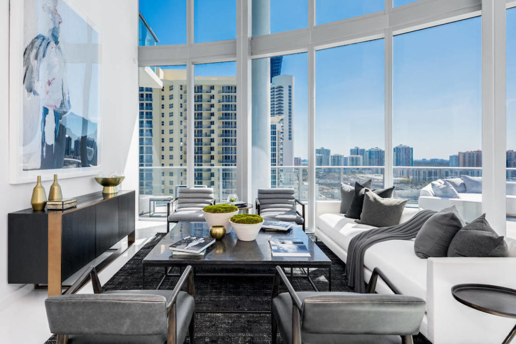 Modern living room with large windows overlooking a cityscape.
