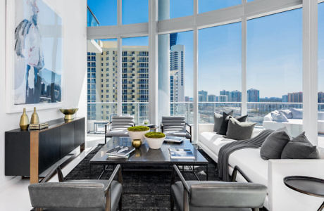 Modern living room with large windows overlooking a cityscape.