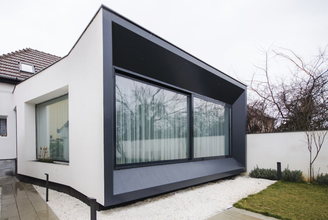 Modern house extension with large windows and a contrasting black and white color scheme.