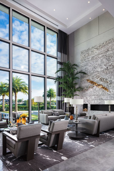 Elegant lounge with floor-to-ceiling windows and chic decor.