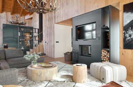 Rustic-chic living room with antler chandelier, wood paneling