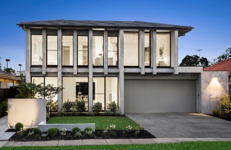 Modern two-story house with large windows and a double garage at dusk.