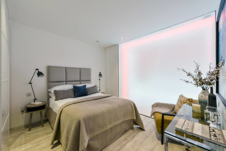 Contemporary bedroom with ambient lighting and minimalist decor.