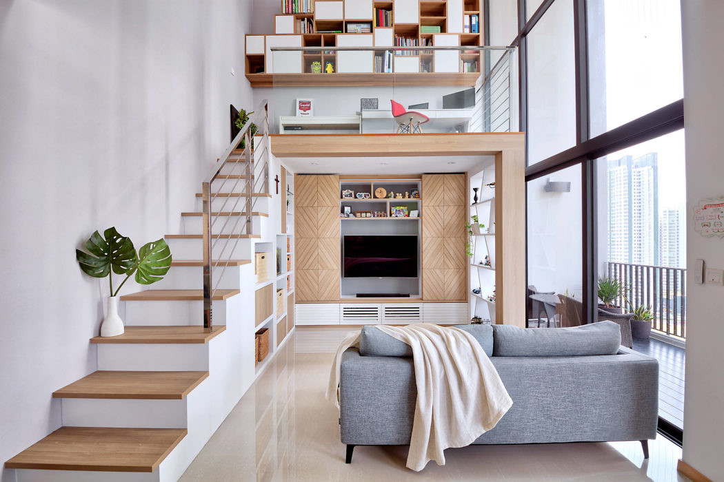 Contemporary living room with a staircase and built-in shelves.