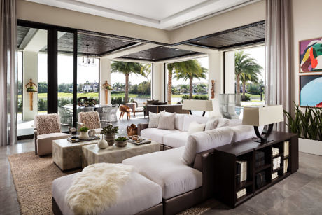 Elegant living room with open patio doors and a tropical view.