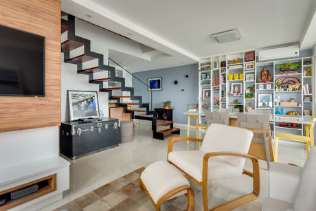 Contemporary living room with floating staircase and gallery wall.
