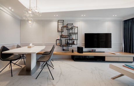 Sleek interior with minimalist dining area and unique shelving unit.