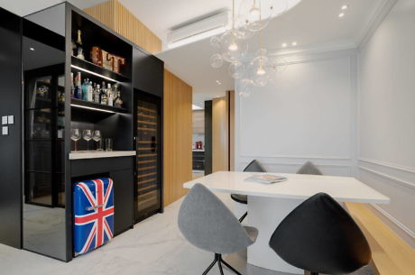 Modern dining area with a black shelving unit, Union Jack decor, and a