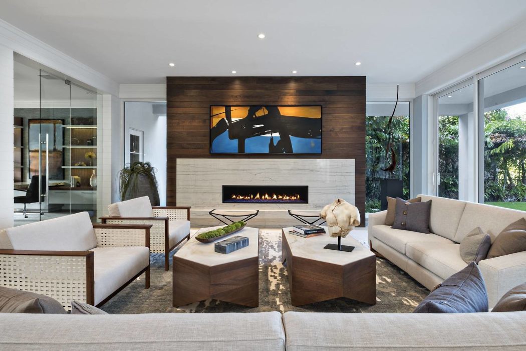 Contemporary living room with sleek fireplace and wood-paneled wall.