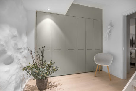 Modern room with built-in wardrobes and minimalist decor.