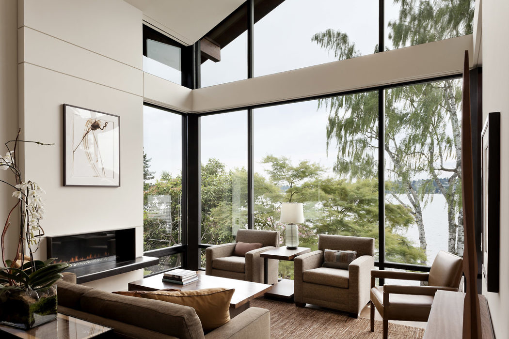 Modern living room with large windows overlooking a scenic view.