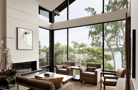 Modern living room with large windows overlooking a scenic view.