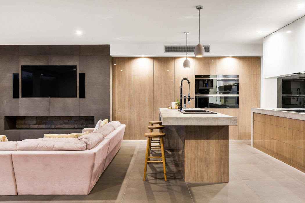 Contemporary open-plan living space with kitchen island and plush sofa.