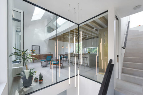 Modern home interior with glass walls, high ceiling, and minimalist decor.