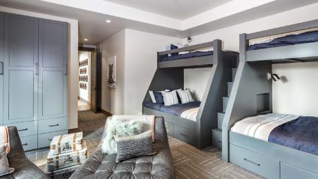 Modern room with stylish bunk beds and a cozy sitting area.