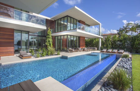 Modern house with large windows, pool, and wooden accents.