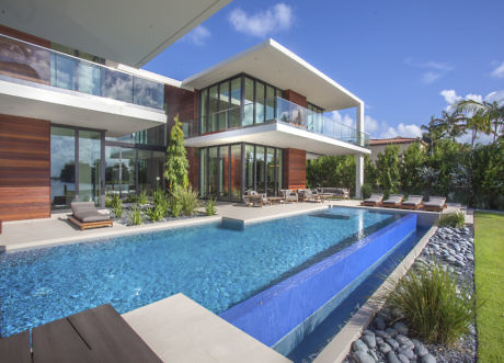 Modern house with large windows, pool, and wooden accents.