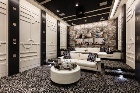 Contemporary living room with white sofa, patterned floor, and abstract art.