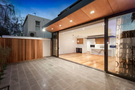 Modern home patio with sliding doors opening to a sleek kitchen.