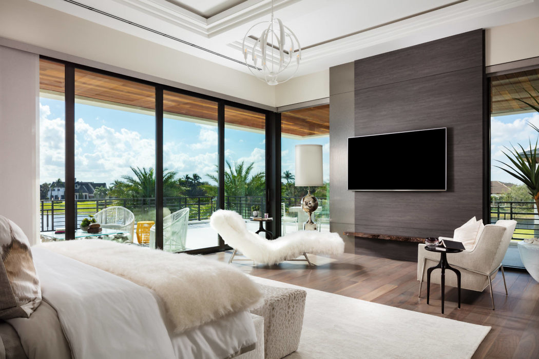 Elegant living room with floor-to-ceiling windows and chic decor.