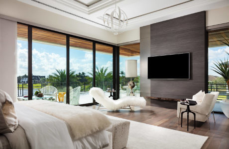 Elegant living room with floor-to-ceiling windows and chic decor.