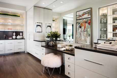 Elegant bathroom with clean white cabinetry, dark countertops, and stylish accents.