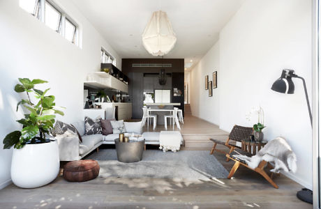 Modern living room interior with natural light and minimalist decor.