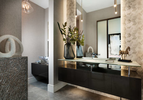 Modern bathroom with double vanity, large mirror, and textured walls.