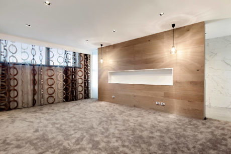 Contemporary room with wooden wall panel and patterned curtains